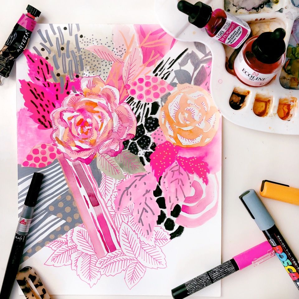 An Amarylis Henderson hand illustration of flowers. Paper on a table with creative accesories: markers, paints and a color palette.